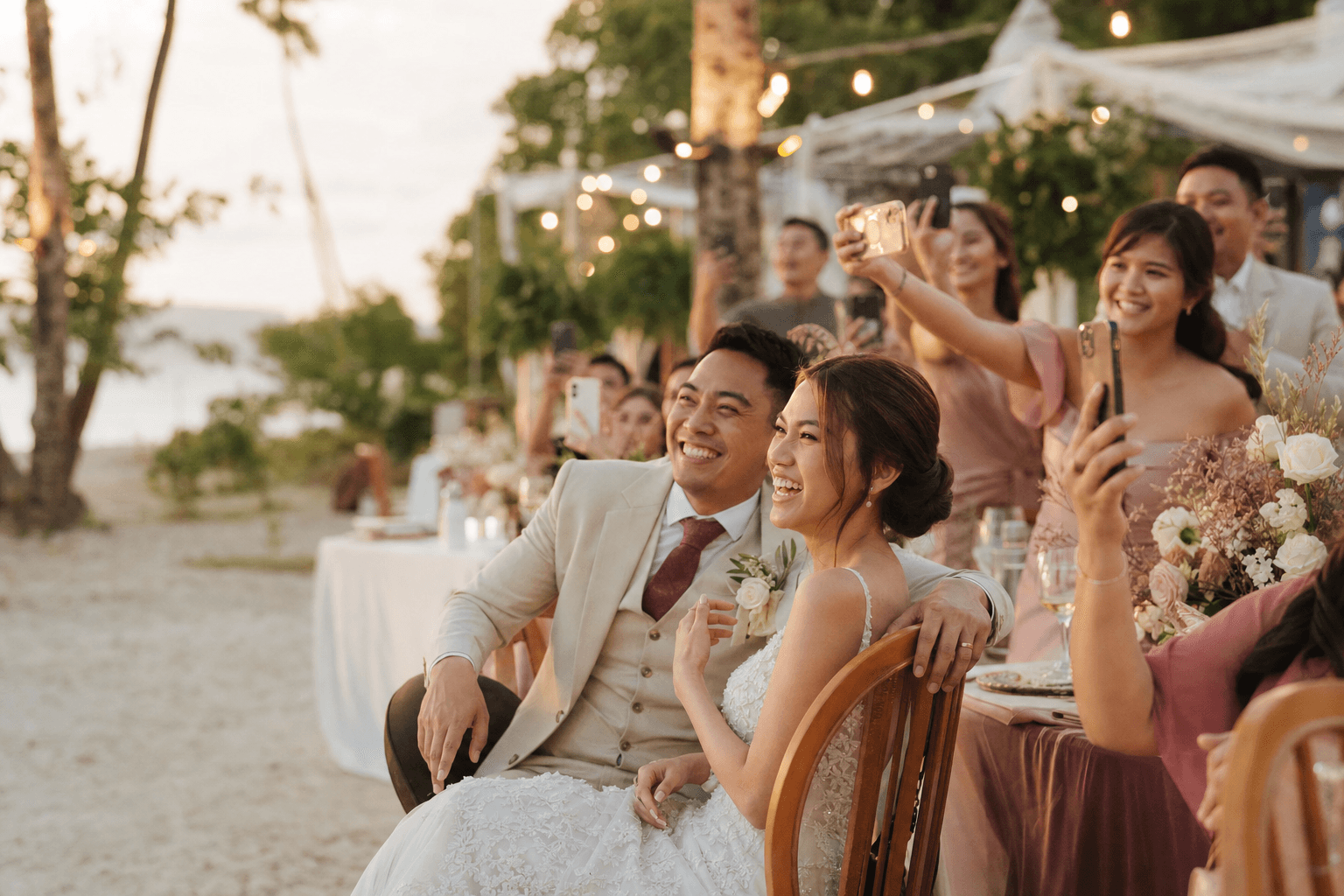 Wedding guests capturing photos on their phones at a reception